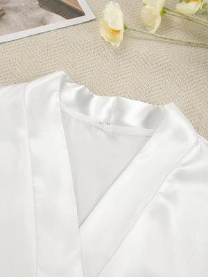 White satin robe with lace trim detail and V-neckline