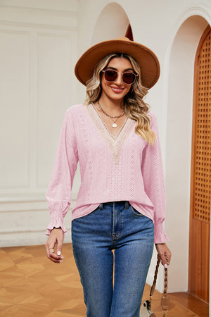 Blush pink eyelet blouse with lace trim and ruffle cuffs.