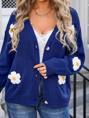 Navy acrylic V-neck cardigan with white daisy appliqués and button front.