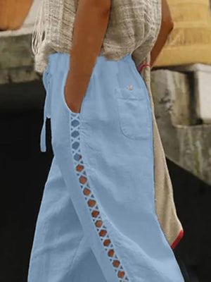 Light blue cropped pants with hollow out trim and drawstring waist.