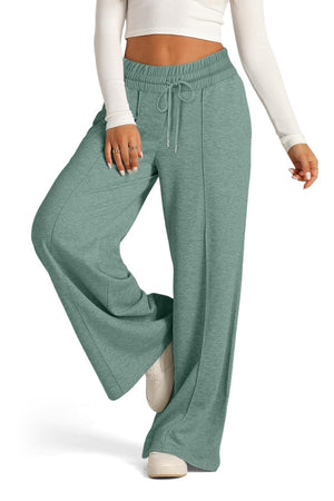 Seamed palazzo lounge trousers in sage green with drawstring waist and wide legs.