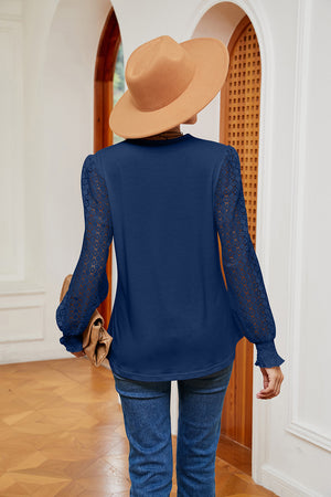 Navy blue knit blouse with lace sleeves and V-neck