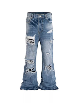 Distressed baggy fit men's blue denim jeans with ripped details.