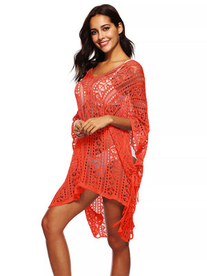 Orange crochet V-neck beach cover-up with intricate cutout pattern and fringe detail.