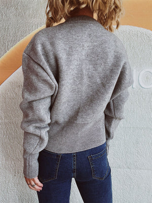 Gray ribbed knit zip-front sweater with a mock neck and ribbed hem