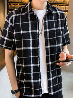 Men's black and white plaid short sleeve button-down shirt with chest pocket.