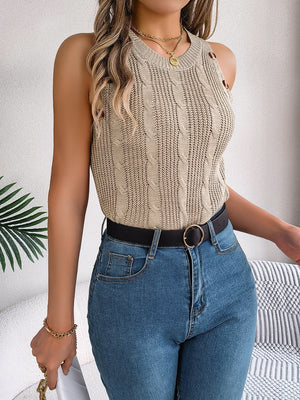 Cable knit tank top in beige with button details on the shoulder, styled with jeans.