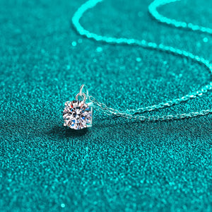 Solitaire moissanite pendant necklace in silver with a delicate chain.