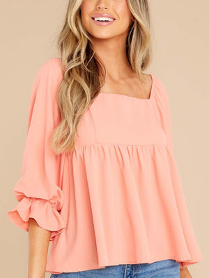 Watermelon pink babydoll blouse with square neckline and ruffled sleeves.