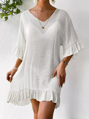 White ruffled V-neck cover-up dress with bell sleeves and textured fabric.