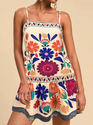 Beige mini dress with a vibrant floral print, square neckline, and spaghetti straps.