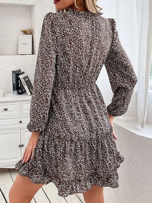 Ruffled tie neck floral mini dress in dark brown with long sleeves and tiered hem.