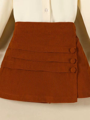 Toddler brown corduroy skort with button detail and tiered pleats.