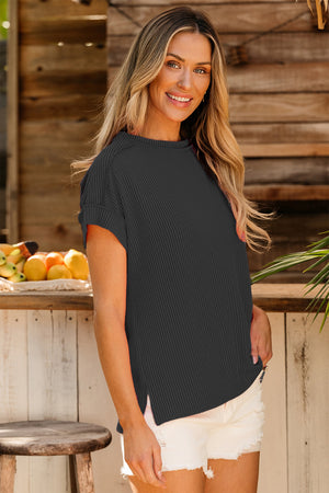 Dark gray ribbed tee with rolled sleeves and side slits, worn casually
