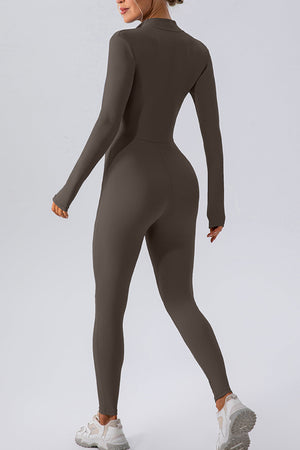 Sculpted zip-front bodycon jumpsuit in chocolate, with long sleeves and a high neckline.