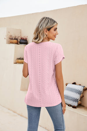 Blush pink knit top with eyelet details and short sleeves.