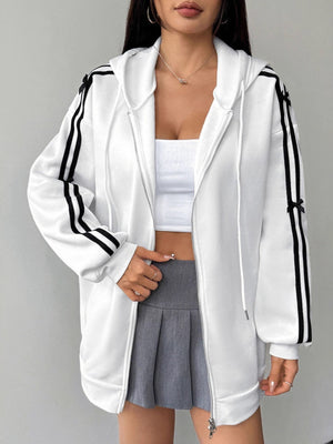 White zip-up hoodie with black stripes and bow details on sleeves.