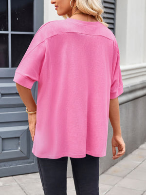 Pink relaxed fit t-shirt with short dolman sleeves and a crew neck.