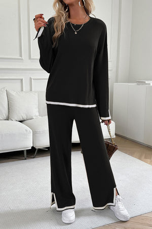Black ribbed knit loungewear set with white trim on sweater cuffs, hem, and pant legs.