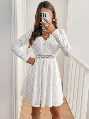 White lace openwork V-neck dress with long sleeves and an a-line skirt.