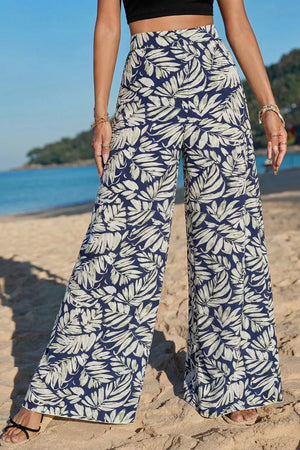 Navy leaf print high-waisted wide-leg maternity trousers in cotton.