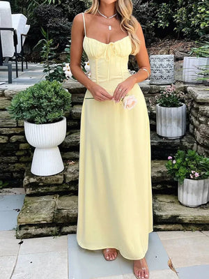 Pastel yellow tie-front maxi dress with spaghetti straps and a cinched waist.