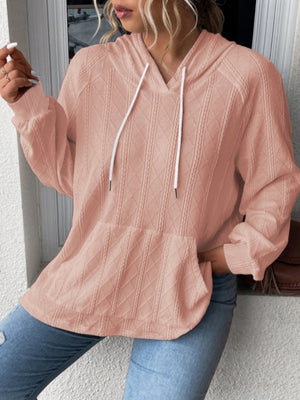 Textured knit raglan hoodie in watermelon pink with white drawstrings and a front pocket.