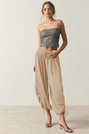 Tan gathered ankle-tie balloon trousers with drawstring waist