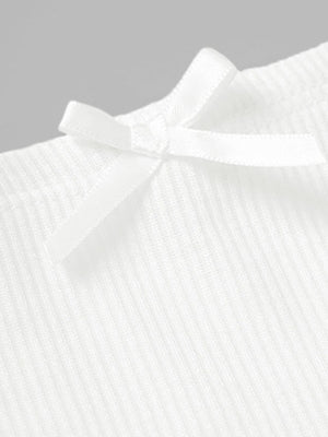 White ribbed mini skirt with a small bow detail.