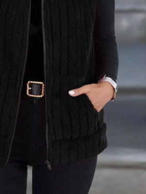 Black fleece zip-up vest with pockets and ribbed texture.