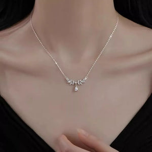 Elegant silver zircon flower pendant necklace with delicate leaf design and teardrop crystal.