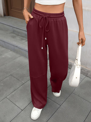 Wine Red high-waist drawstring wide-leg pants with pockets and a relaxed fit.