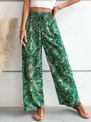Paisley palazzo trousers in dark green with a drawstring waist and wide legs.