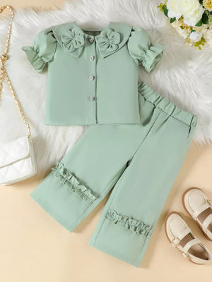 Green toddler set with floral collar, ruffle sleeves, and ruffle hem pants.