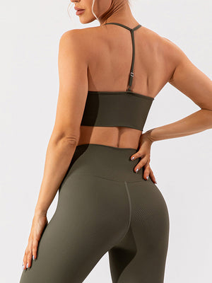 Ribbed halterneck active bra in matcha green with adjustable strap detail.