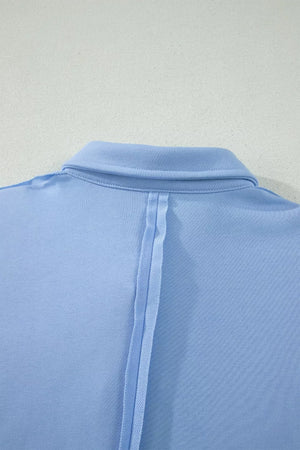 Light blue sleeveless polo shirt with a buttoned collar and vertical seam detail.