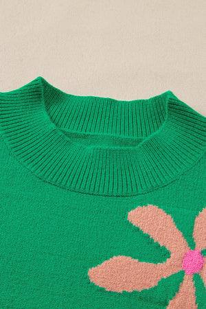 Green knit sweater with a large floral print and ribbed crew neck.
