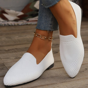White breathable knit pointed-toe flats with a gold chain anklet.