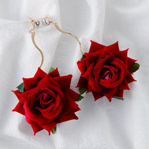 Deep red velvet rose cascade earrings with gold wavy stems and crystal studs