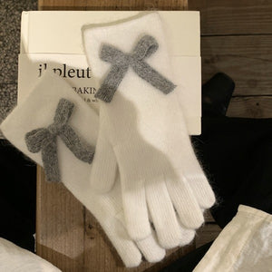 White rabbit fur gloves with gray knit bows detail.