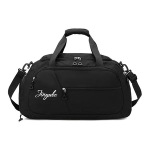 Black travel duffel bag with dual handles, adjustable strap, and logo detail.