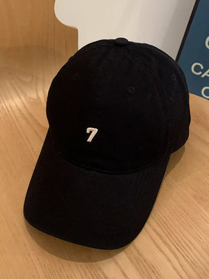 Black cotton baseball cap with embroidered white number 7 detail