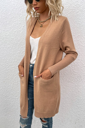 Khaki ribbed cuff open-front cardigan with pockets, worn open over a white tank top.