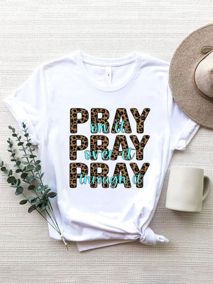 White graphic tee with leopard print text saying Pray on it, Pray over it, Pray through it.