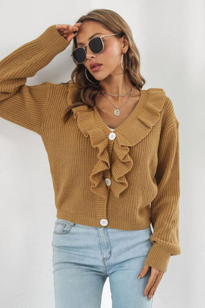 Camel knit cardigan with ruffled collar and white buttons.
