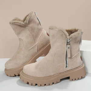 Creamy-white suede ankle boots with faux fur lining and side zipper detail on a chunky sole.
