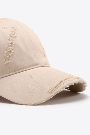 Cream distressed baseball cap with frayed details and stitched brim.