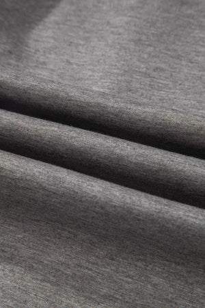 Dark gray knit fabric detail of a chic half-zip polo and wide-leg set.