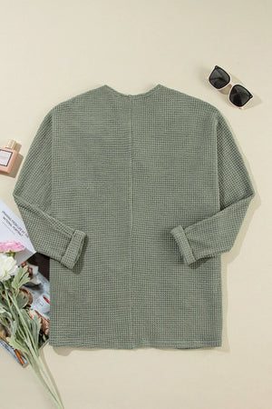 Sage waffle knit open-front duster cardigan with cuffed sleeves.