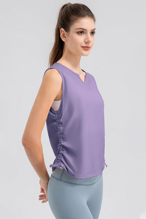 Lavender active tank top with notched neckline and ruched sides.